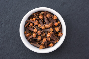 Dried cloves spice isolated on black background.