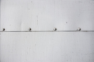 Closeup grunge gray paint metal wall texture with seam and rivets