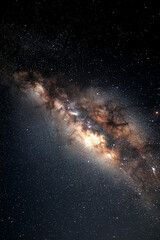 milky way galaxy with luminous core and scattered stars in diagonal cosmic composition featuring bright whites and yellows against dark dust lanes