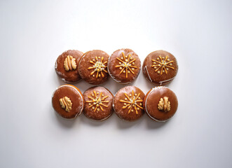 Traditional German Lebkuchen Cookies Isolated on White Background. Soft and spiced German Lebkuchen gingerbread cookies decorated with nuts and glaze. 