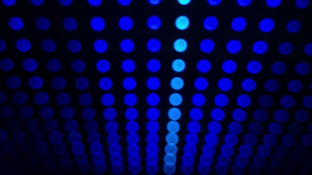Defocused bokeh background with colorful LED lights at the night club