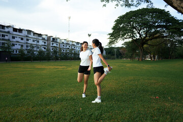 Women stretching in park enjoying active outdoor lifestyle
