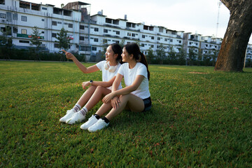 Two women friends sharing outdoor moment in park