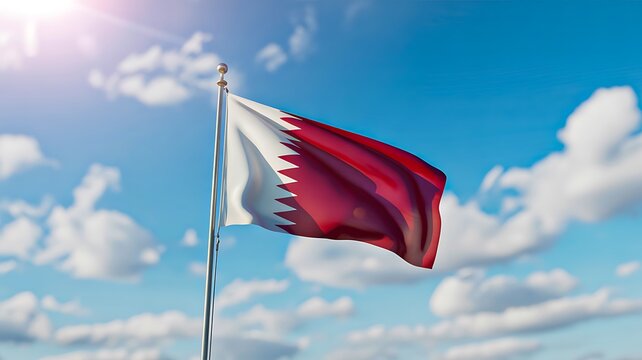 Qatar national flag waving in the wind with blue sky and clouds background
 - Powered by Adobe