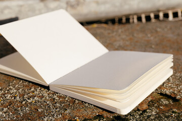 Fototapeta premium Blank white paper notebook on rusty metal background. Copy space.