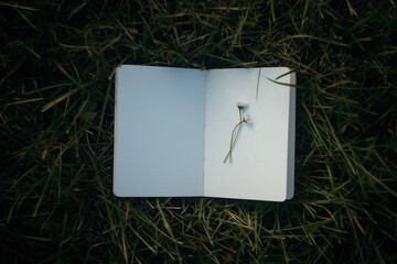 Blank white paper notebook on rusty metal background. Copy space.