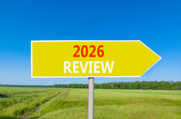 2026 Review symbol. Concept words 2026 Review on beautiful yellow road sign. Beautiful green grass field forest and blue sky background. Business and 2026 review concept. Copy space.