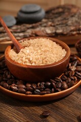 Natural sea salt and coffee beans on wooden table, closeup