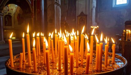 A cluster of lit candles bathed in warm, soft interior lighting