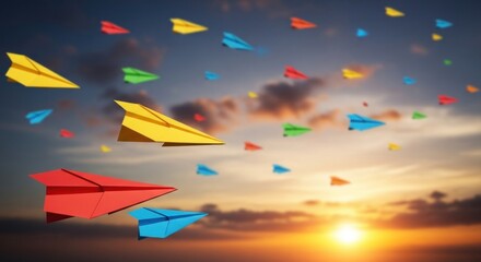 Colorful paper airplanes soaring through the sky at sunset, creating a vibrant scene.