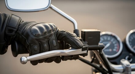 Close-up shot of a person wearing a black leather glove, operating the clutch lever on a motorcycle