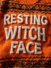 A knitted sweater design that says Resting Witch Face - close up of fuzzy letters on an ugly halloween sweater.