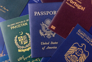 A background of several passports from different countries, an international ID card. Passport