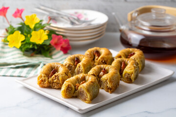 Traditional Turkish dessert called Bulbul Nest , Special baklava with walnut inside and pistachio powder on it, Sherbet dessert which is Turkish name is 'Bulbul Yuvasi'