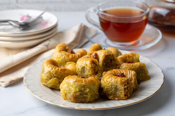 Traditional Turkish dessert called Bulbul Nest , Special baklava with walnut inside and pistachio powder on it, Sherbet dessert which is Turkish name is 'Bulbul Yuvasi'