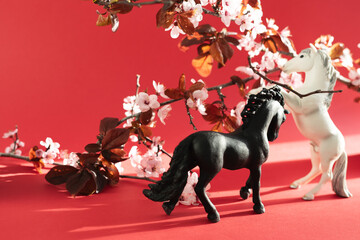 Two horses with plum flowers around him. Chinese New Year 2026.