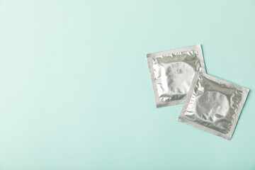 Condoms on a colored background. Colorful fruit-themed condoms in packaging. Safe sex concept....