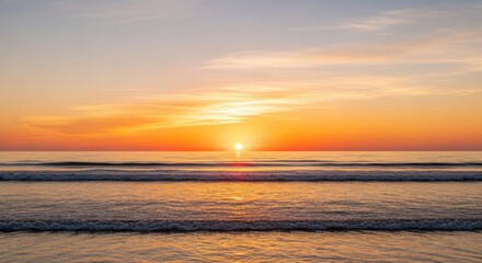 Obraz premium Golden Sunset Over Ocean Waves with Orange Sky