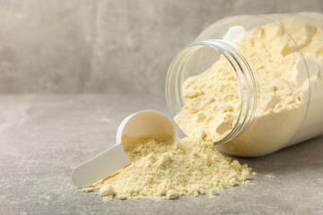 Protein powder. A spoonful of protein powder on a table. Different flavors of whey protein powder. Sports nutrition concept. Gym. Amino acid food supplement, creatine powder. Copy space.