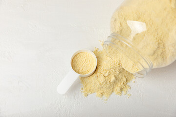 Protein powder. A spoonful of protein powder on a table. Different flavors of whey protein powder....