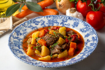 Beef goulash, soup and a stew, made of beef chuck steak, potatoes and plenty of paprika. Hungarian  traditional meal.