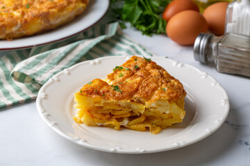 Spanish omelette with potatoes, typical spanish cuisine on gray concrete floor. Tortilla Espanola. Turkish name; Yumurtali patates