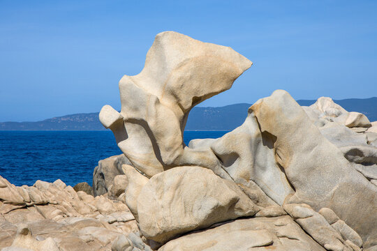 the bizarre granite weathering formations called tafoni on the coast of Campomoro in sunshine and blue skies