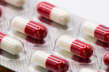 Close up of a blister pack of red and white pills