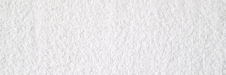 White textured wall background with subtle rough surface details for minimalist designs and projects.