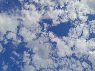 Background with clouds on blue sky. Beautiful sunny sky