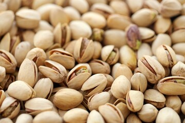 Tasty unpeeled pistachios as background, top view flat lay background