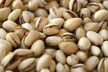 Many tasty unpeeled pistachios top view flat lay background pattern
