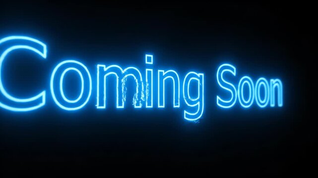 Animated glowing blue neon text announces "Coming Soon" against a stark black background. The electric effect highlights anticipation and future events.
