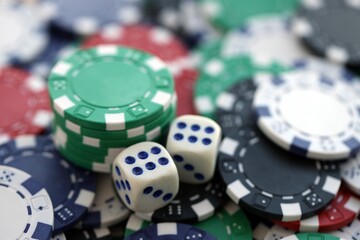Dice game on the poker table in the casino. A successful combination of dice brought a lot of winning chips