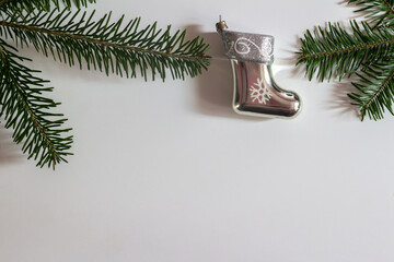 Christmas decoration of boots and Christmas tree branches on a white background. Copy space.