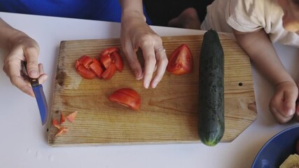 Woman slicing fresh tomato on cutting board - Powered by Adobe