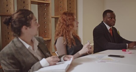 Business professionals collaborate in a startup meeting, discussing data and strategizing. The team actively participates, fostering innovation and growth. - Powered by Adobe