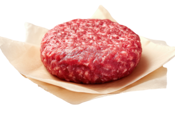 Raw ground beef patty on parchment paper