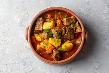 Beef goulash, soup and a stew, made of beef chuck steak, potatoes and plenty of paprika. Hungarian  traditional meal.