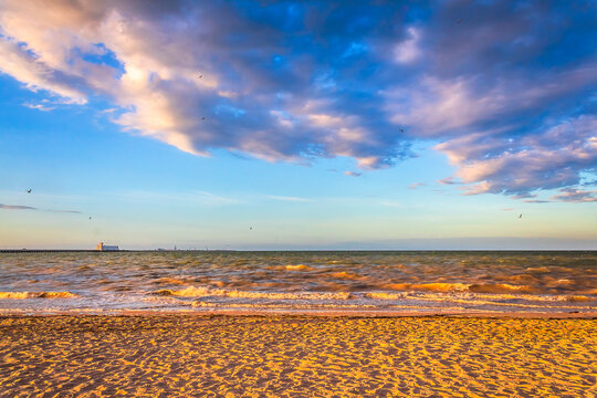 Beach at sunset with seagulls flying in Progreso, YucatanBeach at sunset with seagulls flying in Progreso, Yucatan