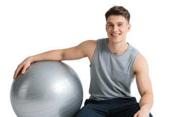 A young man in a tank top sits beside an exercise ball, engaged in fitness training.