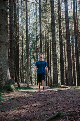 Fototapeta premium A young man walks in the forest