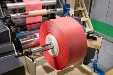 Polyethylene roll for the production of plastic bags. Production of polyethylene packaging. Industrial line for the production of plastic bags. Continuous film production process