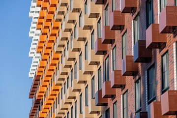 Baskets for placing outdoor air conditioner units on the facade of a new multi-story residential building. Climate control system in a residential building