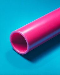 A close up view of a pink cylindrical object on a blue background with a smooth and shiny texture