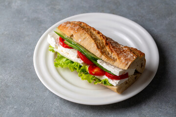 A cold sandwich made with white cheese, tomatoes, cucumbers and greens between bread. Turkish name: ekmek arasi peynir domates