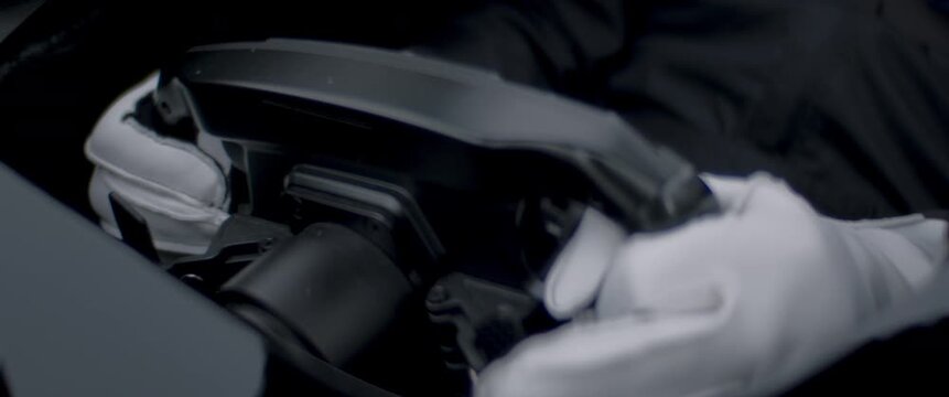 Close-up of a race car driver in a driving fast on a racing track, evening race