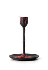 Black metal candle holder covered with red wax drips, isolated on white background, gothic style object.