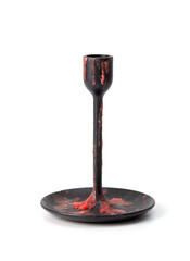 Black metal candle holder covered with red wax drips, isolated on white background, gothic style object.
