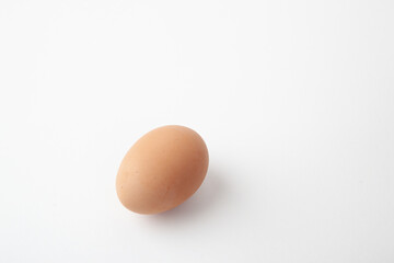 This is a photograph of a single brown chicken egg on a white background. The egg has a smooth, pale brown shell.
It is a common type of egg produced by chickens.